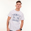 Man wearing a white t-shirt with 'Trinity 1592 College Dublin' text on a plain background