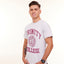 Man wearing a light grey t-shirt with 'Trinity College' printed on it against a white background
