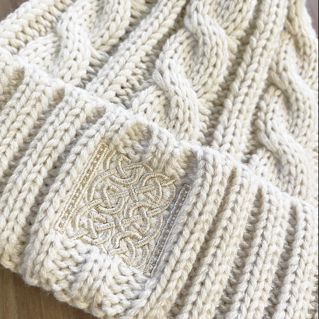 Book of Kells Cable Knit Bobble Hat in Beige